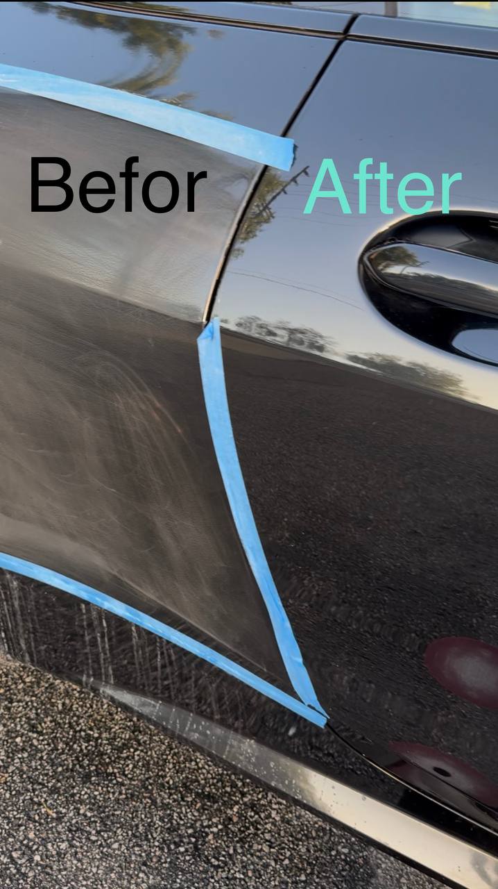 Before and after paint correction on the same door panel, divided by painter's tape — hazy on the left, mirror-glossy on the right